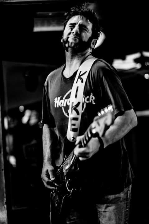 Kike en directo con camiseta del Hard Rock y guitarra eléctrica